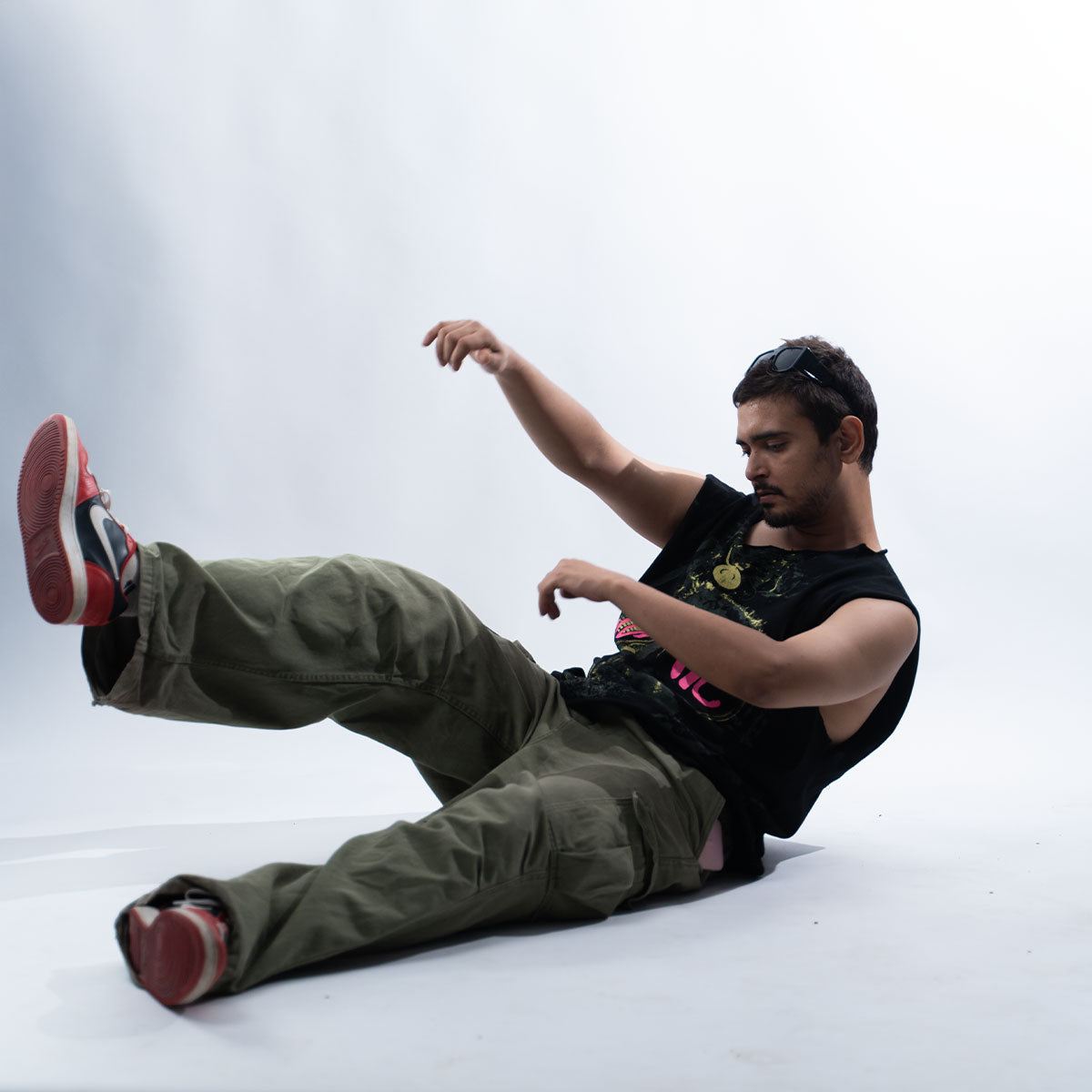 Side view Frappe Ash in relaxed pose wearing black JUNKIE vest 