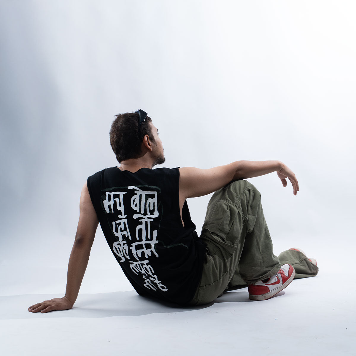  Back view  Frappe Ash wearing black JUNKIE vest with Hindi typography